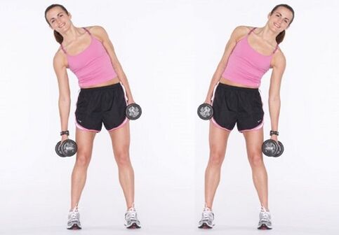 Pompes latérales avec haltères pour renforcer les muscles abdominaux.